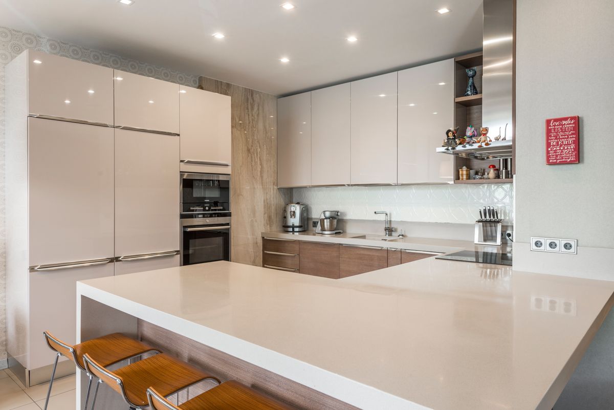 Bright contemporary kitchen with white cabinets and a large countertop island.